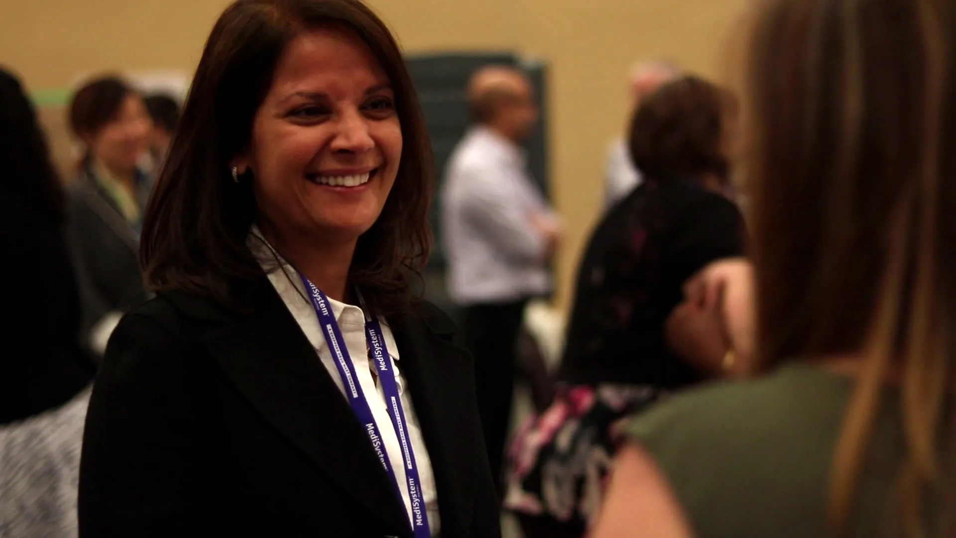 A participant smiles during a buyer conversation practice at a Sell Naturally experience