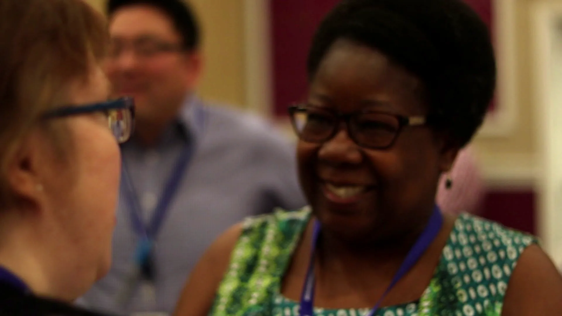 Two participants laughing together during a practice conversation at a Communicate Naturally experience